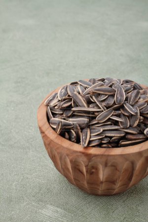 Photo for Black beans in wooden bowl on wooden surface. top view - Royalty Free Image