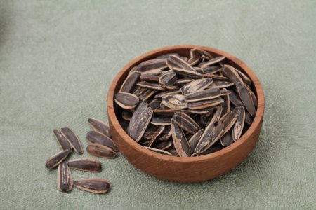 Photo for Bowl of raw brown beans with seeds on grey background, flat lay - Royalty Free Image