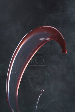 Photo for Red wine splash isolated on black background - Royalty Free Image