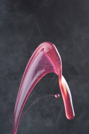 Photo for Splash of fresh cherry juice on a dark background - Royalty Free Image