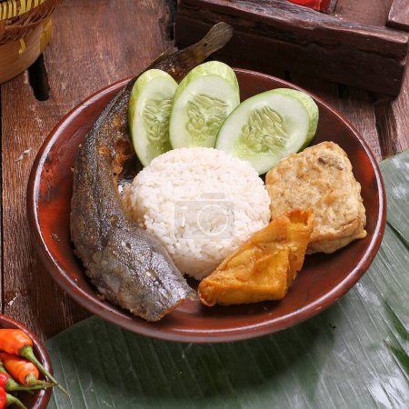 Photo for Fried fish with sticky rice and vegetables on plate - Royalty Free Image