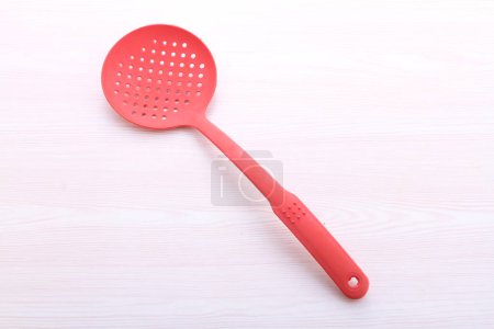 Photo for Red plastic spoon for cooking - Royalty Free Image