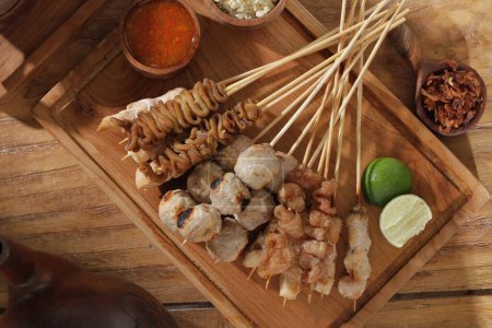 Photo for Sate taichan is a variation of chicken satay grilled and served without peanut or ketjap seasoning unlike other satays. It is served with sambal and squeezed key lime, - Royalty Free Image