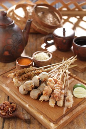 Photo for Sate taichan is a variation of chicken satay grilled and served without peanut or ketjap seasoning unlike other satays. It is served with sambal and squeezed key lime, - Royalty Free Image