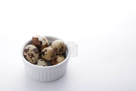 Photo for Quail eggs in a bowl isolated on a white background. - Royalty Free Image