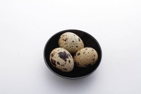 Photo for Quail eggs in a bowl on a white background, healthy eating concept - Royalty Free Image
