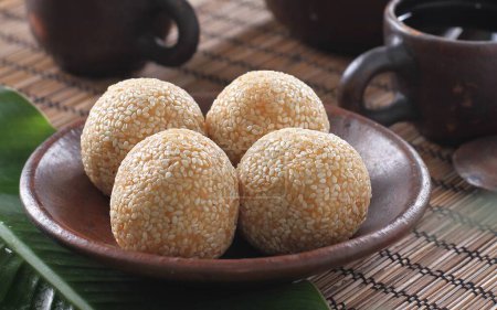 Photo for Onde Onde is a round cake with sesame seeds sprinkled on the outside and green beans on the inside - Royalty Free Image