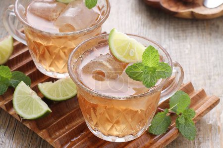 Photo for Iced tea with lemon and mint leaves - Royalty Free Image