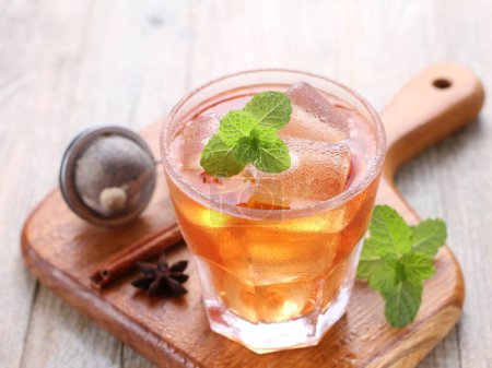 Photo for Glass of ice tea with lemon and mint on wooden background - Royalty Free Image
