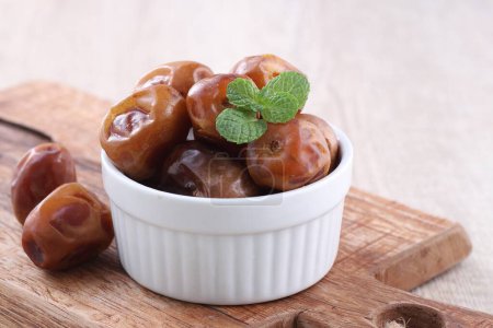 Photo for Sweet dates with mint leaves - Royalty Free Image
