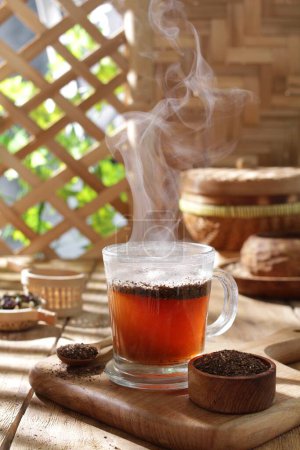Photo for Cup of hot drink on wooden table in autumn - Royalty Free Image