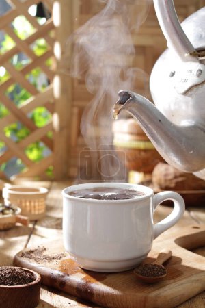 Photo for Hot tea with hot drink and teapot - Royalty Free Image