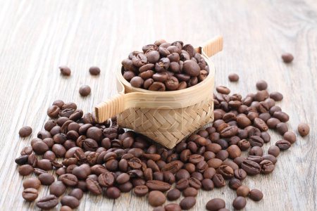 Photo for Roasted coffee beans with coffee beans and wood background - Royalty Free Image