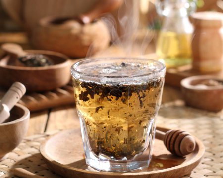 Foto de Té caliente en una taza sobre una mesa de madera - Imagen libre de derechos