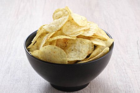 Photo for Bowl of tasty potato chips on grey background, flat lay. space for text - Royalty Free Image