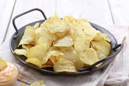 Foto de Tazón de sabrosos nachos de patata con salsa en la mesa blanca, primer plano - Imagen libre de derechos