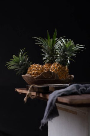 Photo for Still life with pineapple on a wooden table - Royalty Free Image