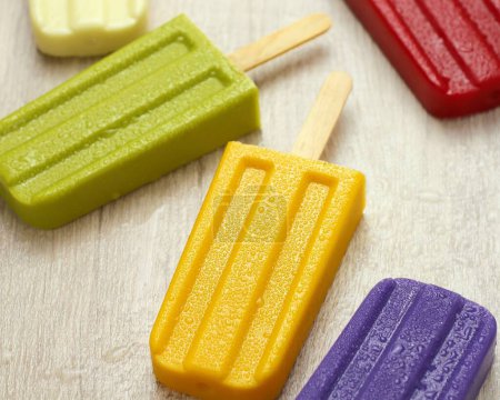 Photo for Colorful popsicle on wood - Royalty Free Image