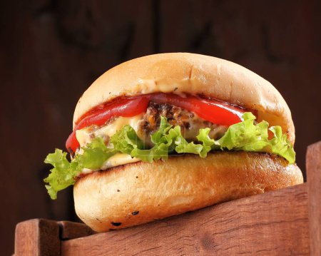 Photo for Delicious burger with meat, vegetables and cheese - Royalty Free Image