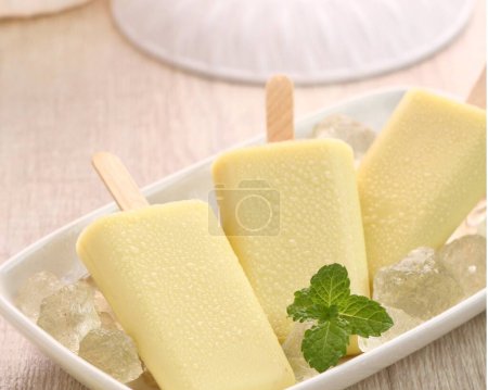 Photo for Ice cream with mint leaves and mint on wooden table - Royalty Free Image