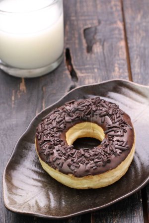 Photo for Tasty chocolate donut and donut on wooden table - Royalty Free Image