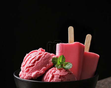 Photo for Strawberry ice cream in a glass cup with ice cream on a black background, summer concept, close up - Royalty Free Image