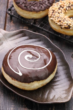 Photo for Chocolate donut with icing and chocolate glaze - Royalty Free Image