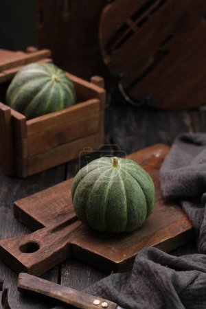 Photo for Fresh green organic pumpkin on wooden background - Royalty Free Image