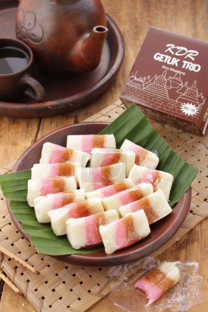 Photo for Dodol is a snack made from sticky rice flour, coconut milk, and brown sugar, sometimes mixed with fruit, such as durian, soursop wrapped in leaves (corn), paper, and so on. - Royalty Free Image