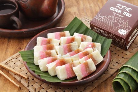 Photo for Dodol is a snack made from sticky rice flour, coconut milk, and brown sugar, sometimes mixed with fruit, such as durian, soursop wrapped in leaves (corn), paper, and so on. - Royalty Free Image