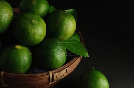 Photo for Green leaves and fruits on a wooden background - Royalty Free Image