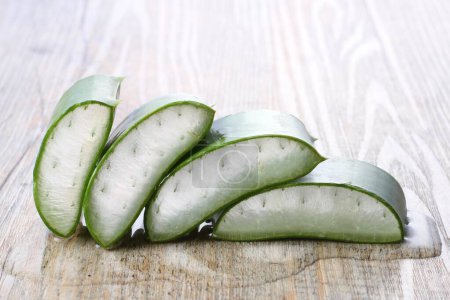 Photo for Aloe vera sliced on white wooden background. - Royalty Free Image