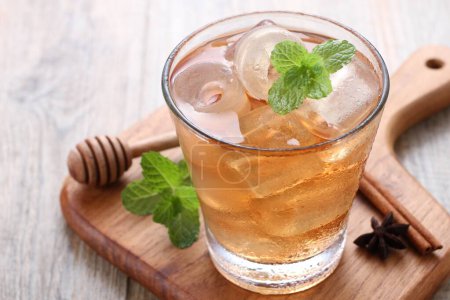 Photo for Glass with tasty refreshing drink and mint on wooden table - Royalty Free Image