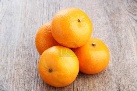 Photo for Orange and tangerines on the wooden background - Royalty Free Image