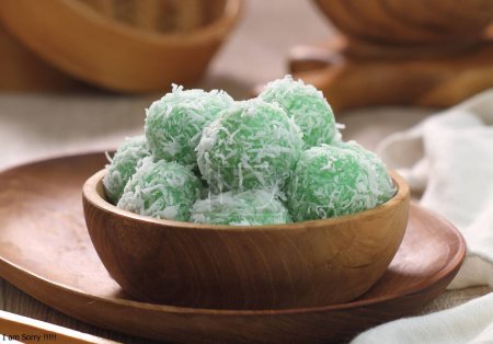 Photo for A bowl of green candy on a wooden plate - Royalty Free Image