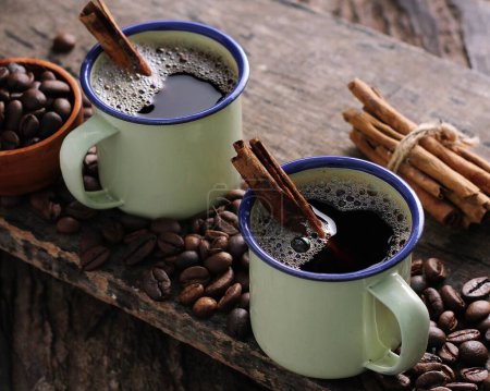 Photo for Two cups of coffee with cinnamon sticks and coffee beans - Royalty Free Image