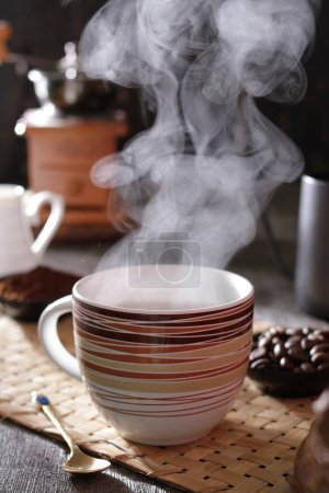 Photo for A steaming cup of coffee on a table - Royalty Free Image