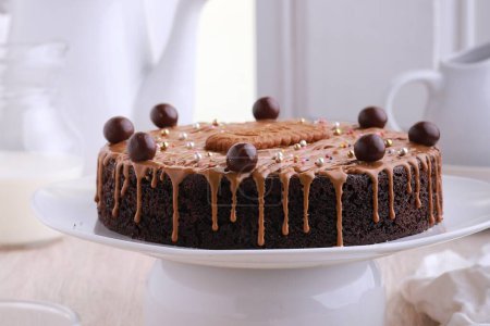 Photo for A cake with chocolate icing and chocolate balls on top - Royalty Free Image