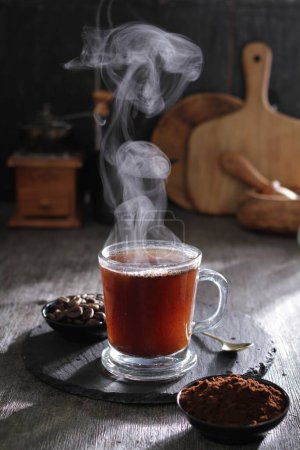 Photo for A cup of hot tea with steam rising out of it - Royalty Free Image