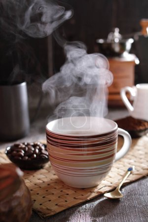 Photo for A steaming cup of coffee on a table - Royalty Free Image