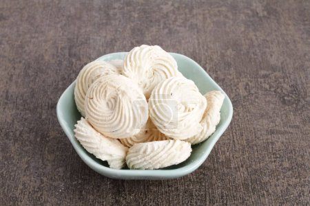 Photo for A bowl of meringue cookies on a table - Royalty Free Image