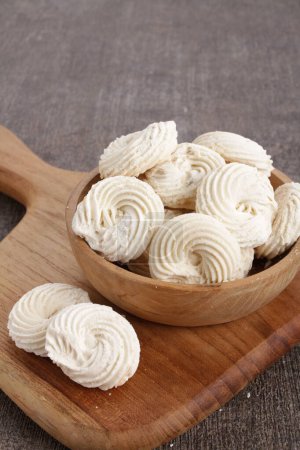 Photo for A wooden bowl filled with whipped cream on top of a cutting board - Royalty Free Image