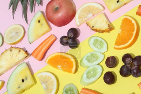 Photo for A variety of fruits and vegetables on a yellow and pink background - Royalty Free Image