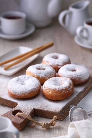 Photo for A wooden cutting board topped with doughnuts and coffee - Royalty Free Image