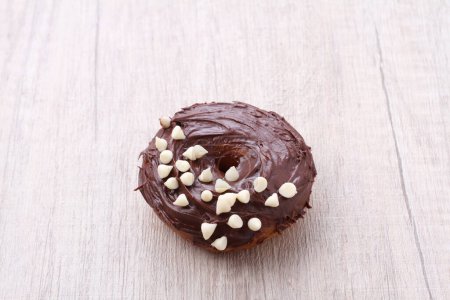 Photo for A chocolate frosted donut with white sprinkles - Royalty Free Image