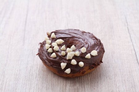 Photo for A chocolate frosted donut with white chocolate sprinkles - Royalty Free Image