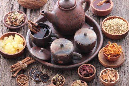 Photo for A variety of spices and teapots on a wooden table - Royalty Free Image