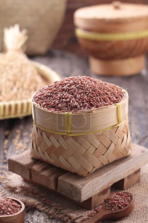 Photo for A basket of red rice on a wooden table - Royalty Free Image