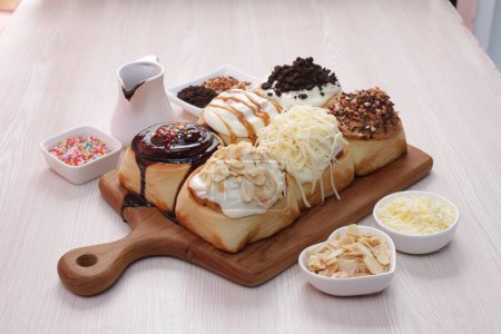 Téléchargez les photos : Un plan grand angle d'un délicieux beignet au chocolat avec une crème fouettée sur une surface blanche - en image libre de droit