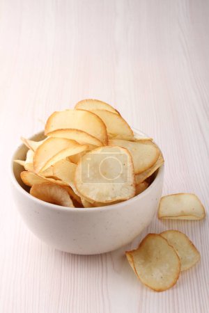 Photo for Chips with a bowl of salt and pepper, closeup, top view - Royalty Free Image